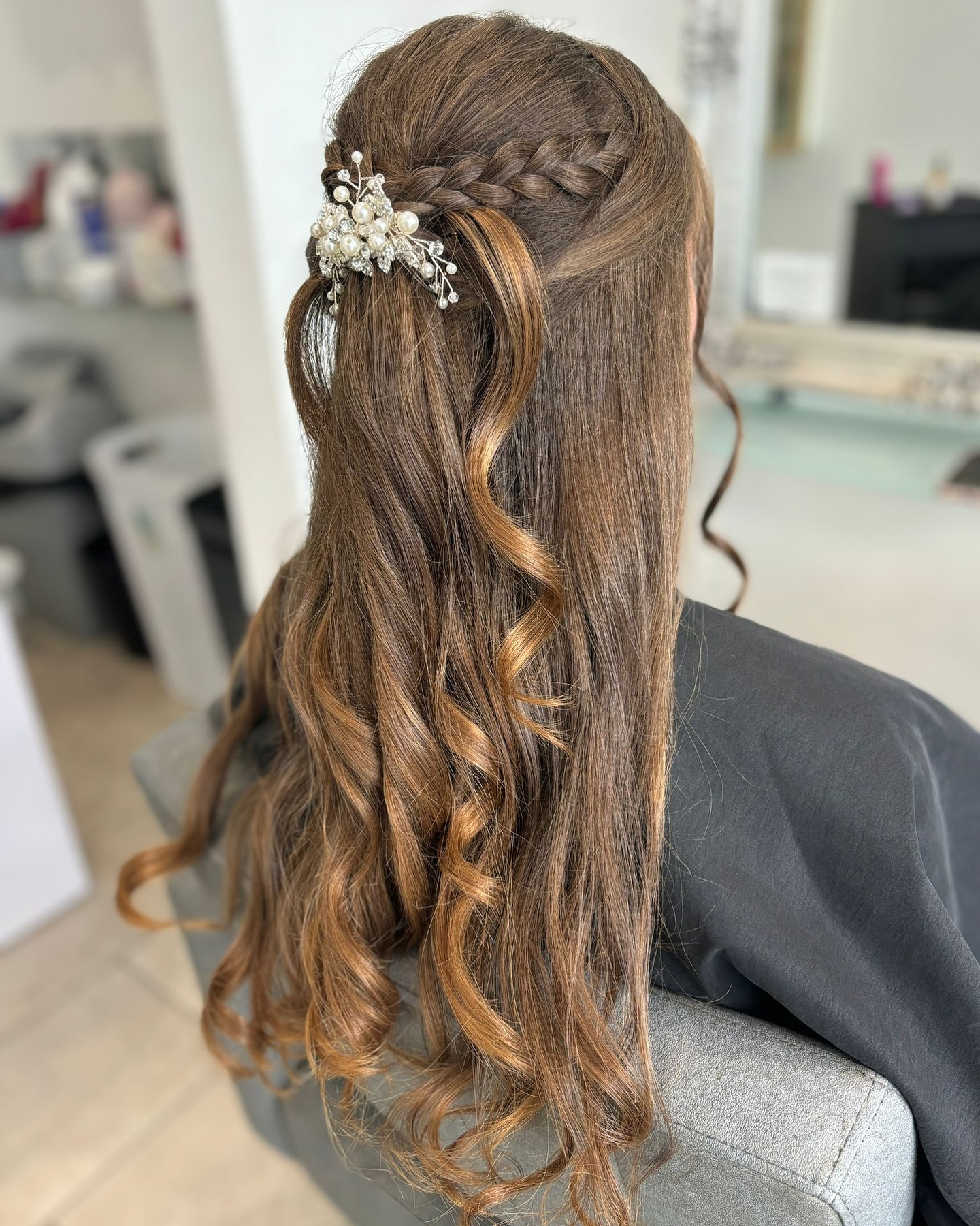 Bridal braided hairstyle with soft curls and elegant detail.