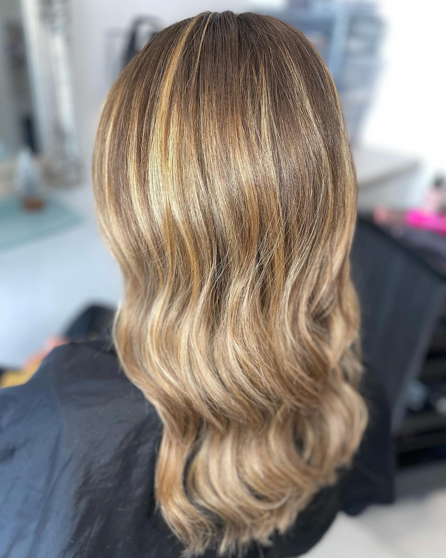 Bronde balayage with soft waves and natural dimension.