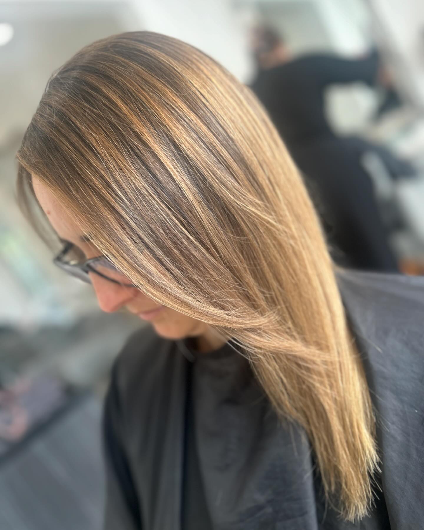 Long hair with bronde highlights and a glossy finish.