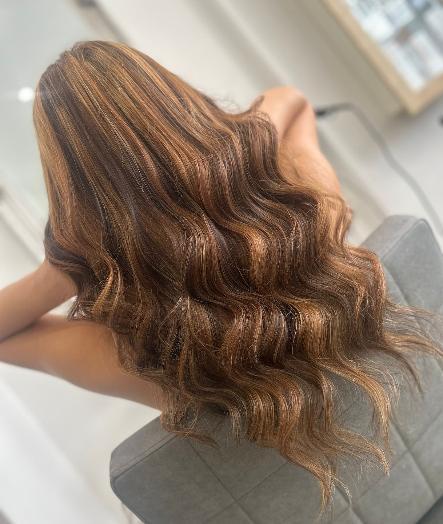 Brunette balayage with soft waves and dimensional colour.