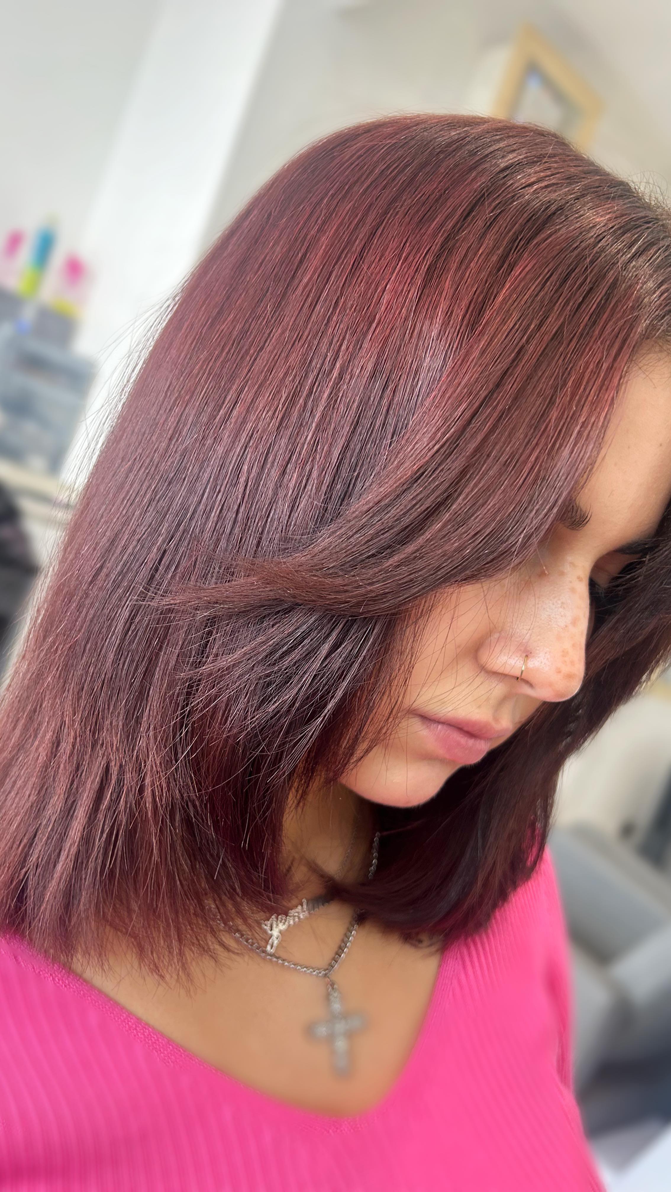 Burgundy bob haircut with a sleek, glossy finish.