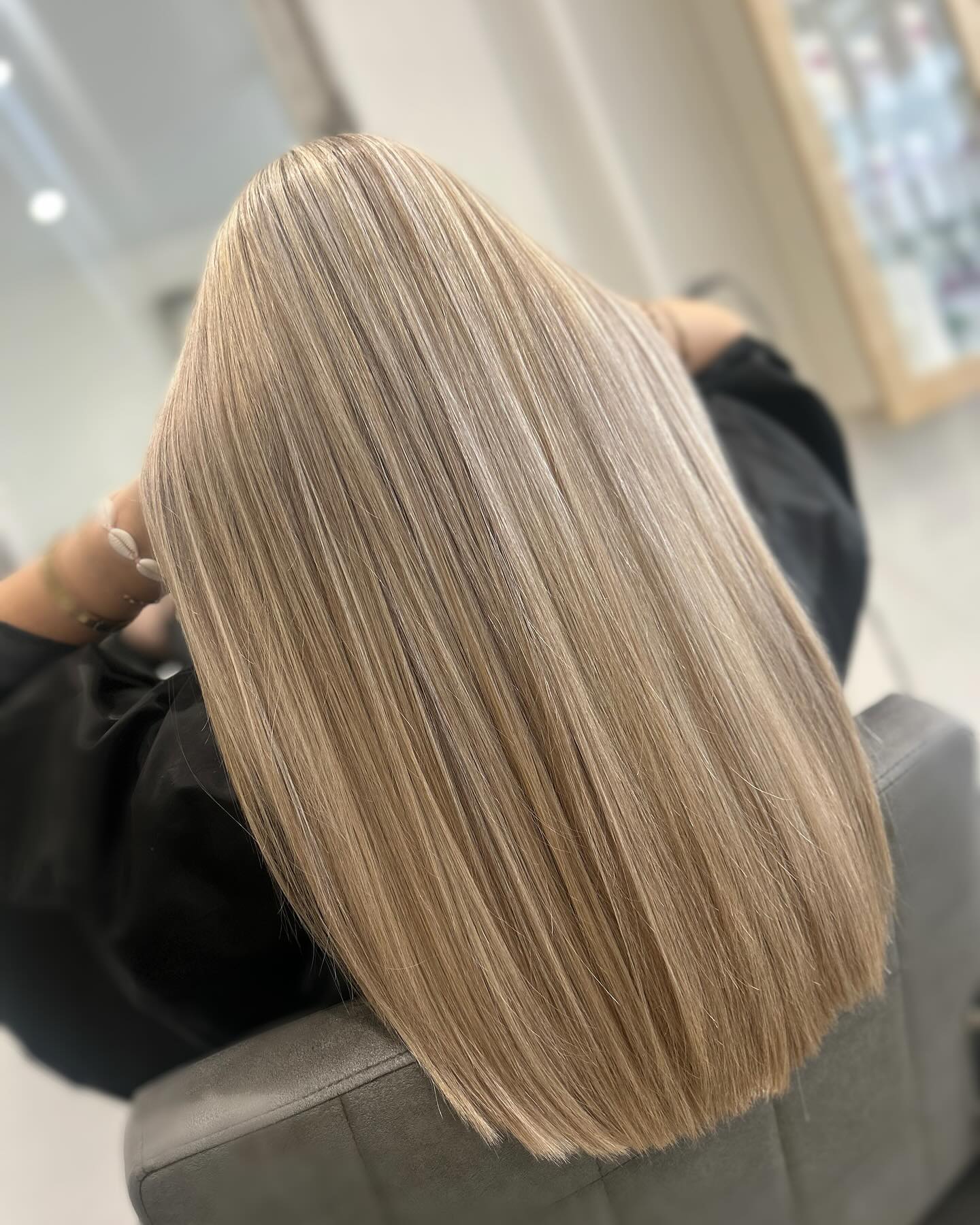 Cool blonde full-head highlights with a bright polished finish.