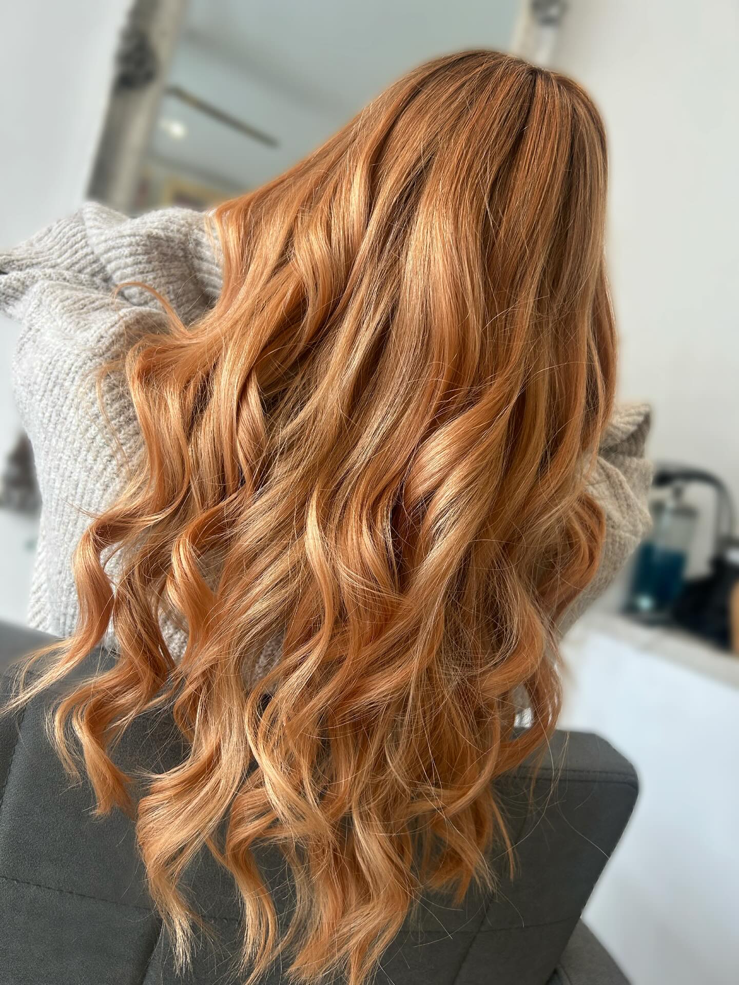 Copper balayage on long hair with soft flowing waves.