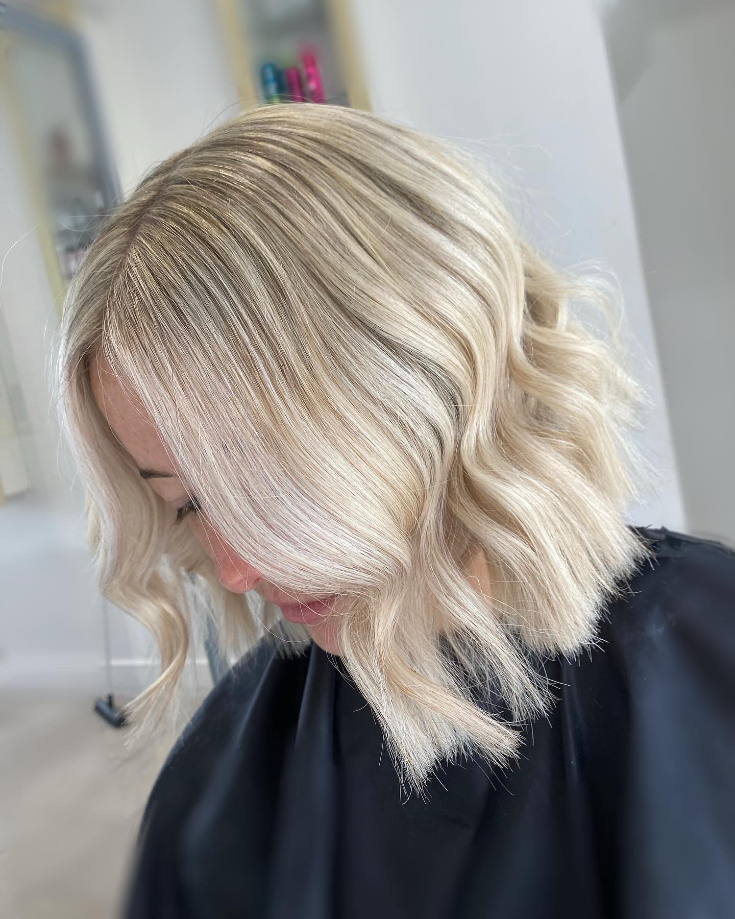 Icy blonde textured bob with soft waves and bright dimensional colour.