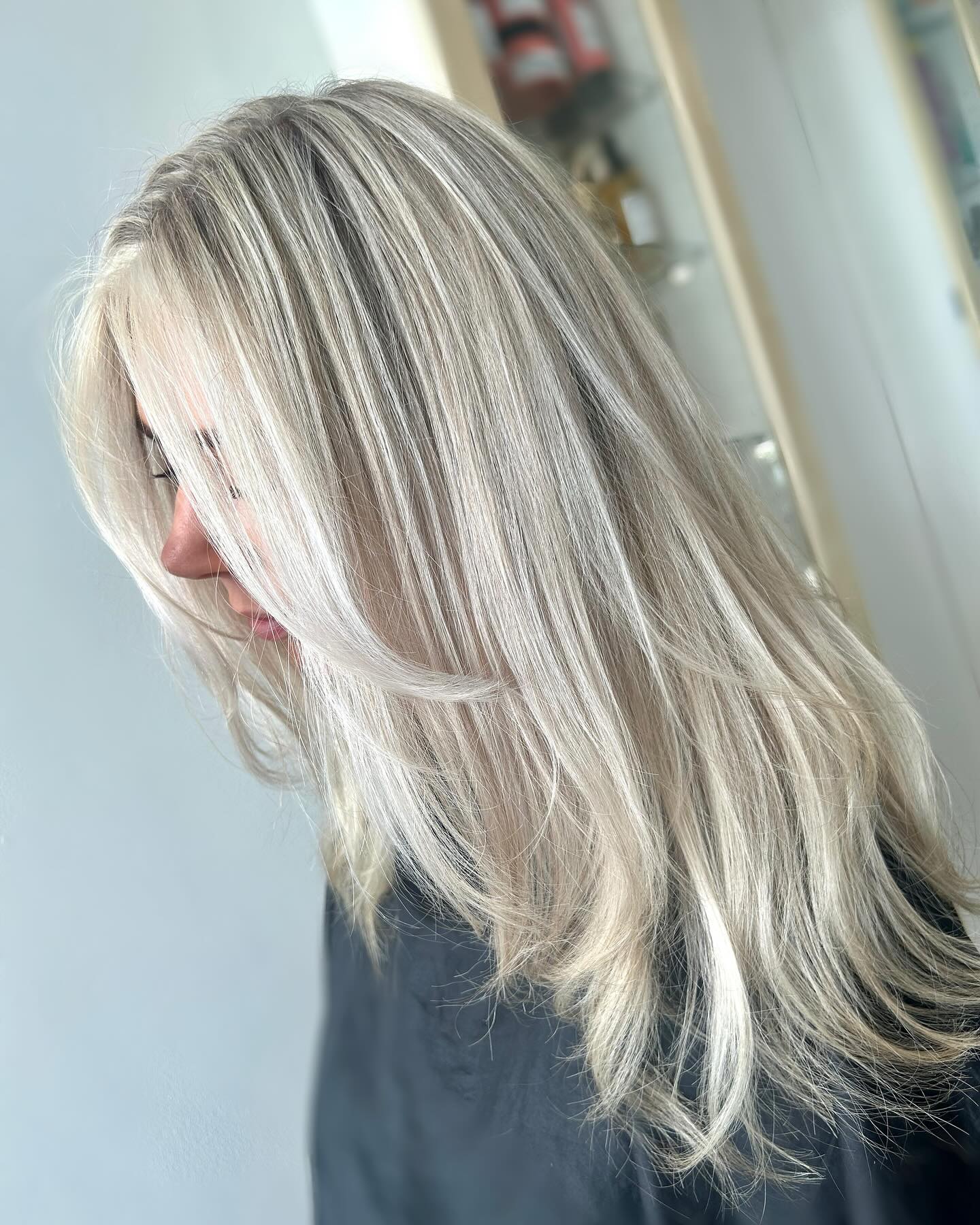 Icy platinum blonde layered cut with a bright finish.