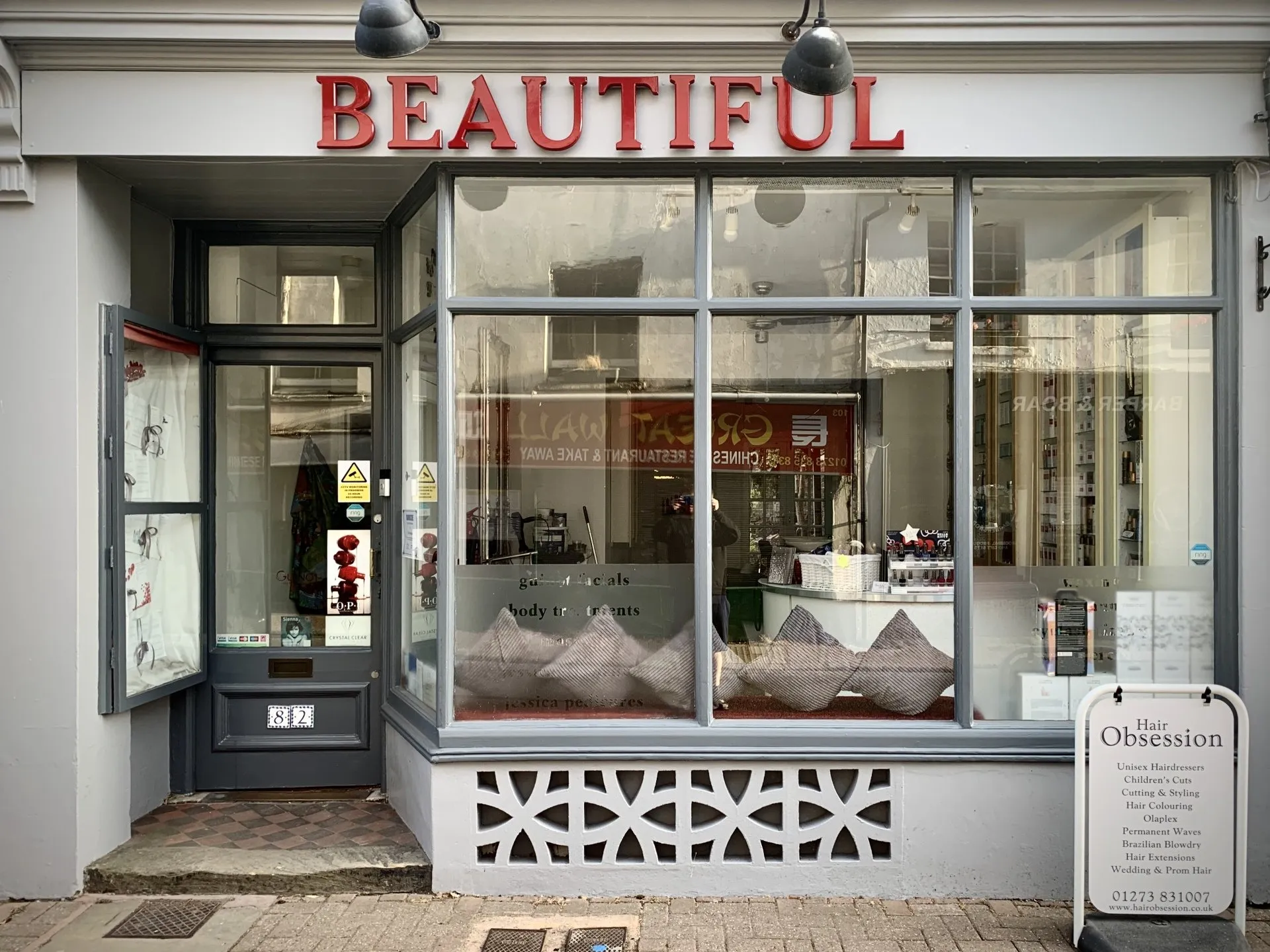 Hair Obsession salon exterior on Hurstpierpoint High Street in West Sussex, showing the shopfront entrance and large front windows.